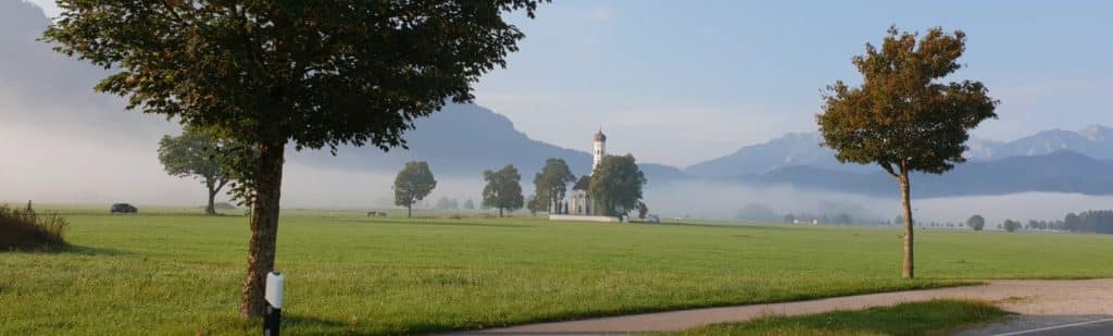 Southern Germany early morning mist-trees-church
